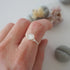 Minimalist rainbow moonstone ring for women in sterling silver wire wrap on hand, dainty June birthstone stacking ring.