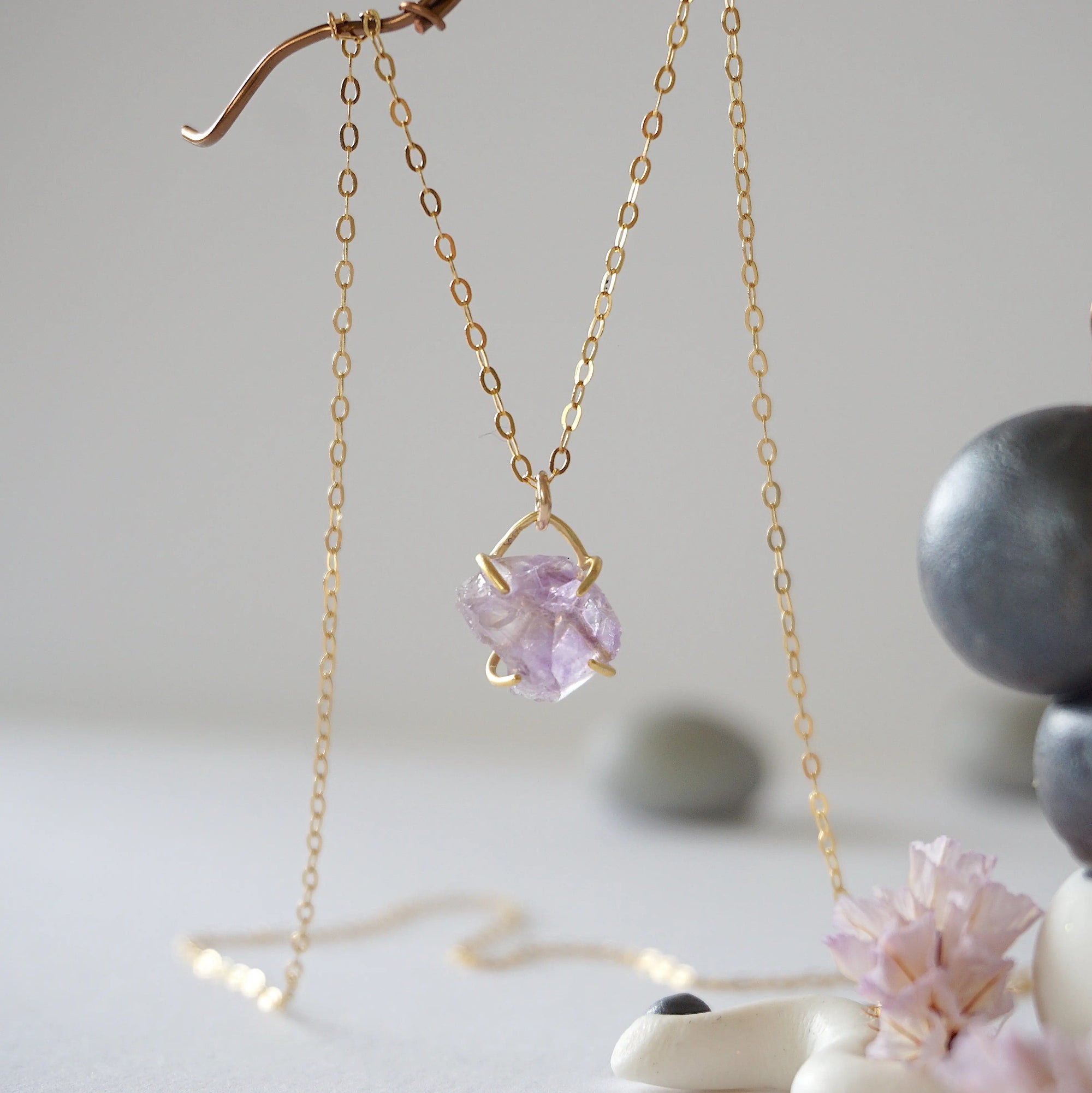 Front view of minimalist raw amethyst necklace in 14k gold vermeil claw setting on 14k gold filled chain, February birthstone