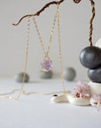 Side view of raw amethyst crystal pendant necklace in 14k gold vermeil claw setting on 14k gold filled cable chain