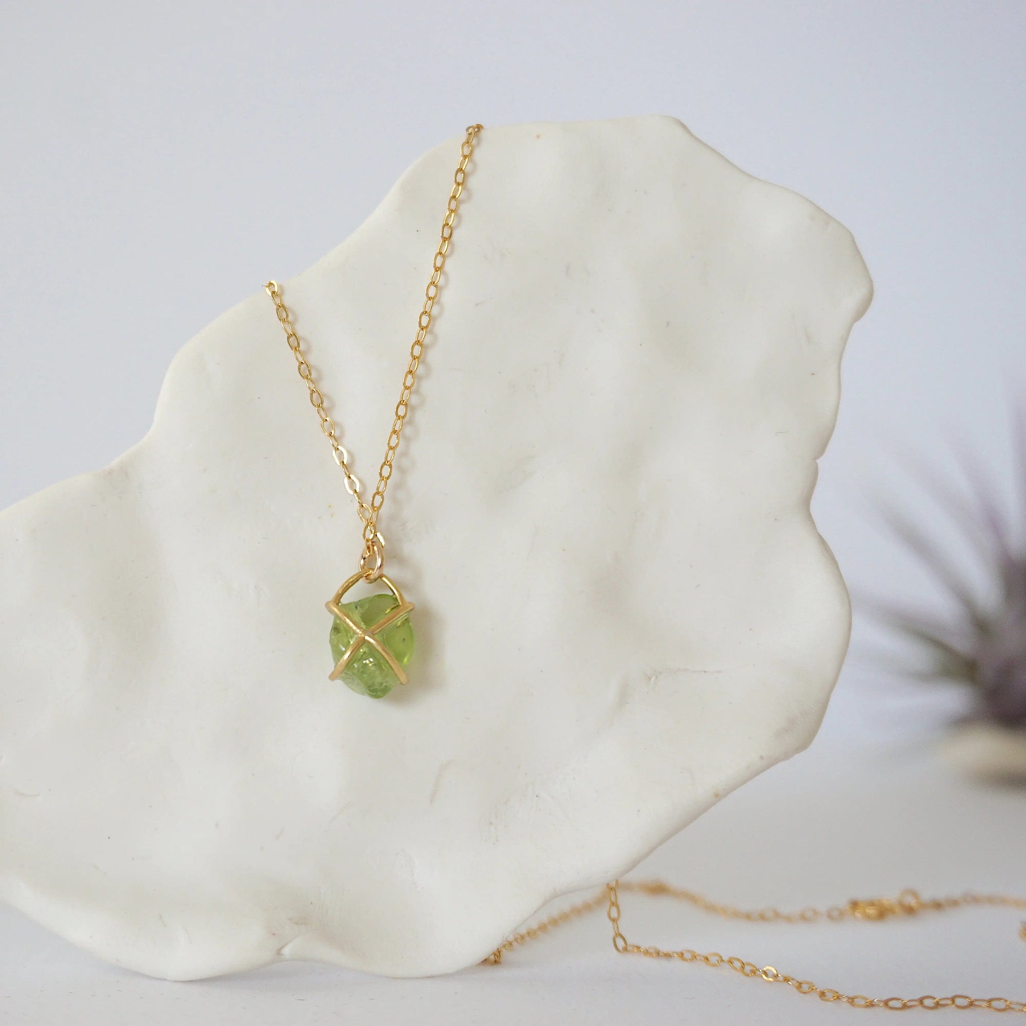 Back view of minimalist raw peridot pendant — gold vermeil prong setting and bail detail, dainty handcrafted crystal necklace for women, August birthstone jewelry