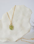 Back view of minimalist raw peridot pendant — gold vermeil prong setting and bail detail, dainty handcrafted crystal necklace for women, August birthstone jewelry