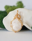 Back angle detail of moonstone and freshwater pearl pendant, showing wire wrapping and natural stone