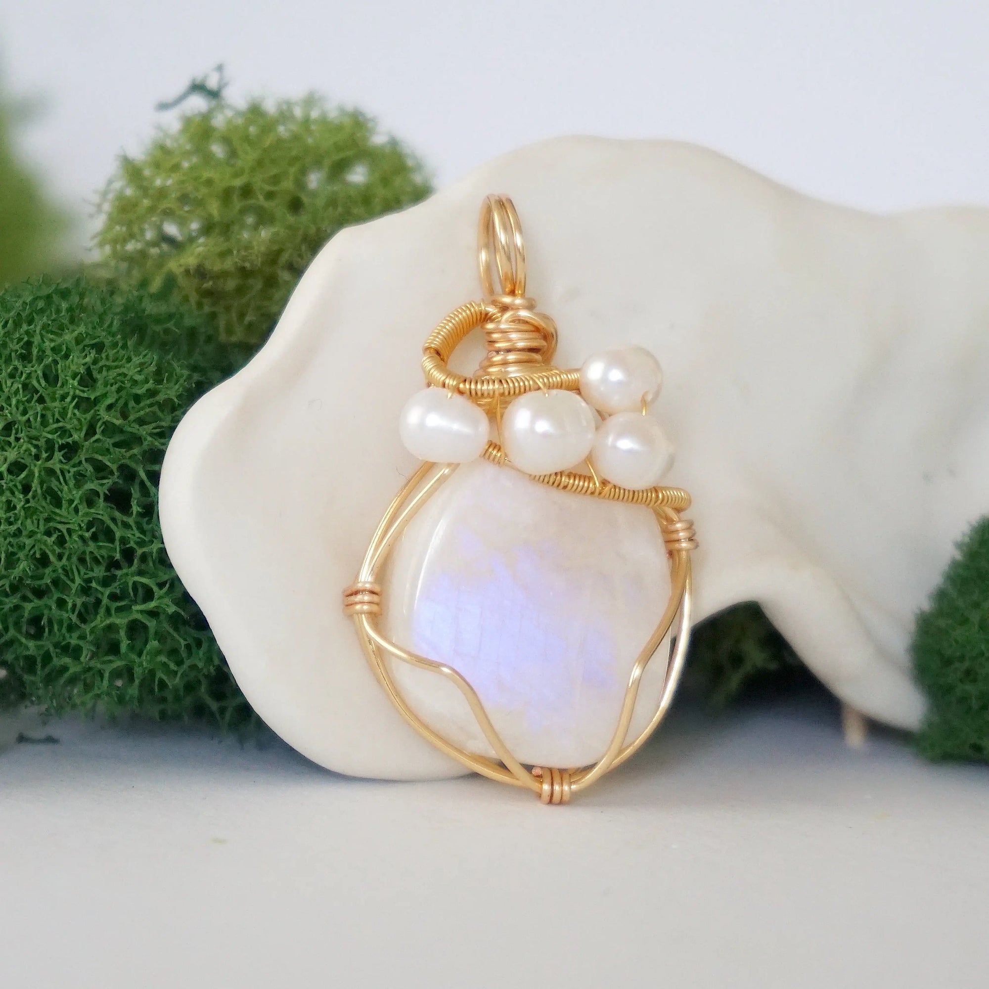 Side angle detail of moonstone and freshwater pearl pendant, gold wire wrapped, ethical artisan necklace