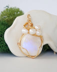 Side angle detail of moonstone and freshwater pearl pendant, gold wire wrapped, ethical artisan necklace