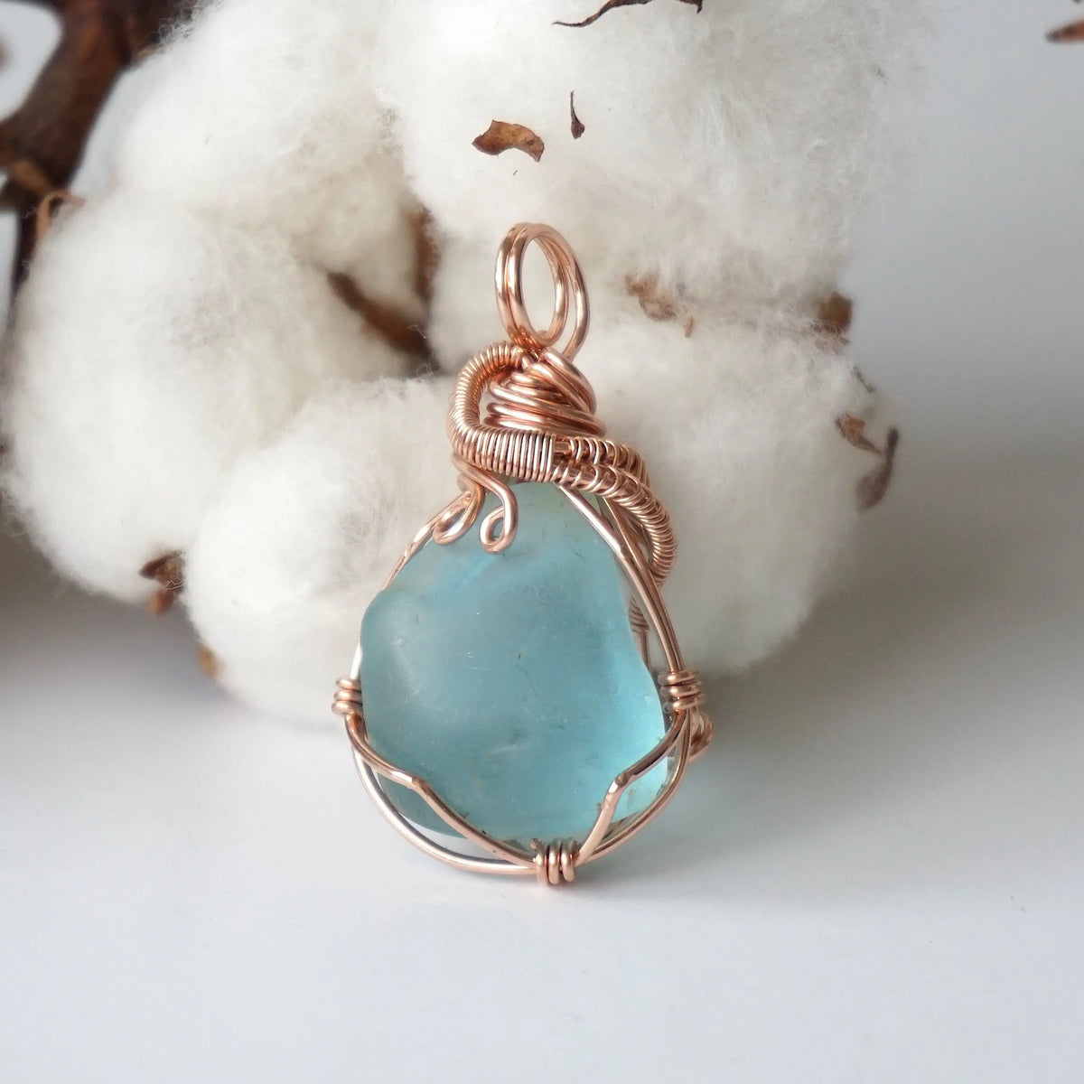 Natural blue topaz pendant hand wire-wrapped in 14k rose gold filled, front view