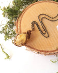Natural citrine necklace laying flat on antique bronze copper chain - handmade wire wrapped crystal pendant full view vintage boho jewelry for women November birthstone