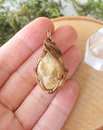 Natural citrine pendant held in hand showing size scale - wire wrapped crystal in antique bronze copper handmade necklace size reference vintage jewelry