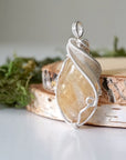 Side angle of natural citrine pendant showing crystal dimension and wire wrap detail - silver plated copper handmade minimalist necklace profile view jewelry