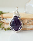 Front view of polished dark amethyst pendant necklace, detailed sterling silver wire wrap