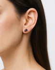 Natural garnet stud earrings on female model with sterling silver posts, dainty minimalist January birthstone jewelry