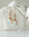 Detailed front view of opal drop earrings, natural faceted opal with minimalist 14k gold filled wire wrapping, Designs by Nature Gems