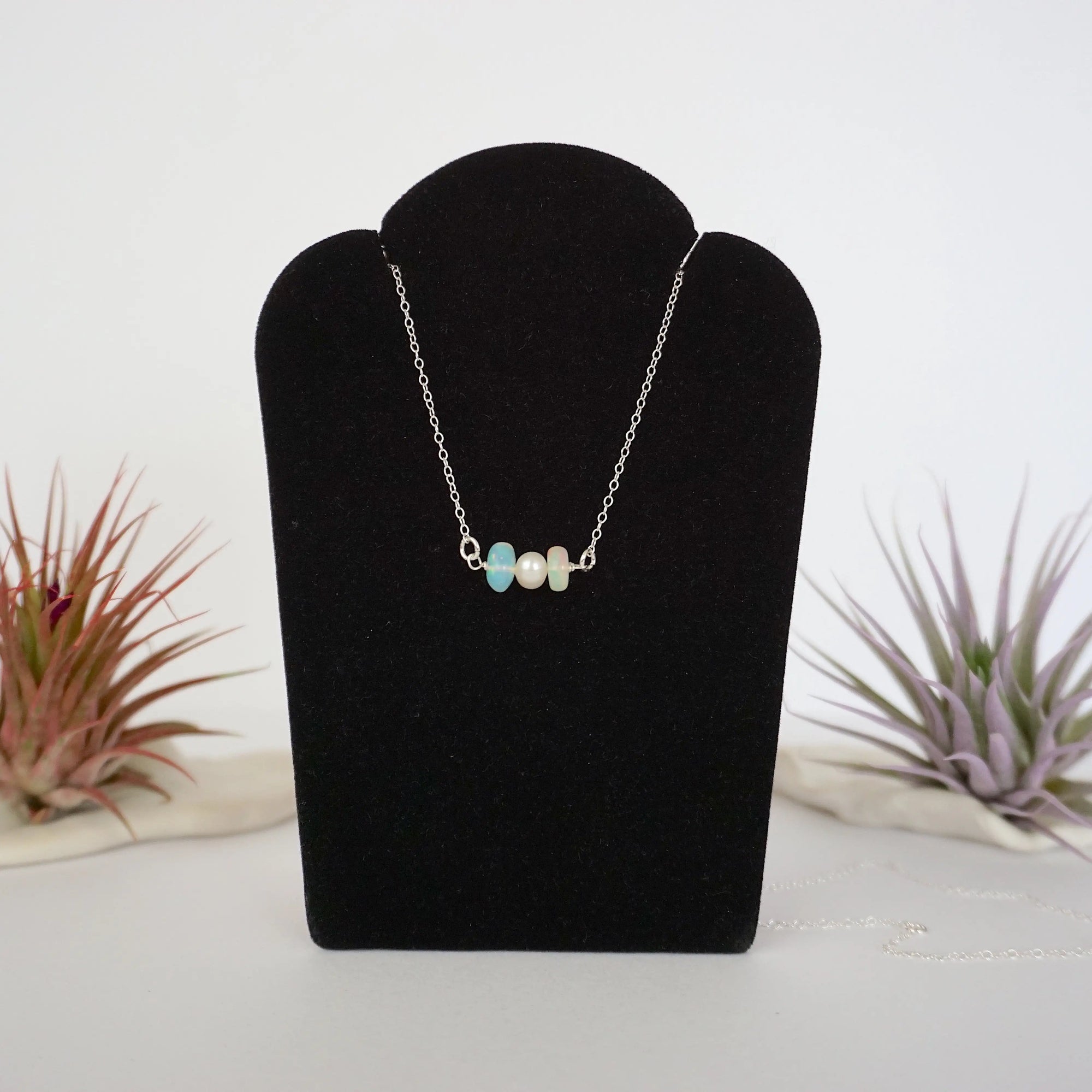 Opal and freshwater pearl bar necklace in 925 sterling silver on jewelry display, front view