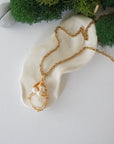 Opal and freshwater pearl pendant on gold plated brass chain laying flat, handmade wire wrapped jewelry for women