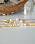 Three women’s pearl and moonstone leather bracelets showing natural variation in freshwater pearls and rainbow moonstone