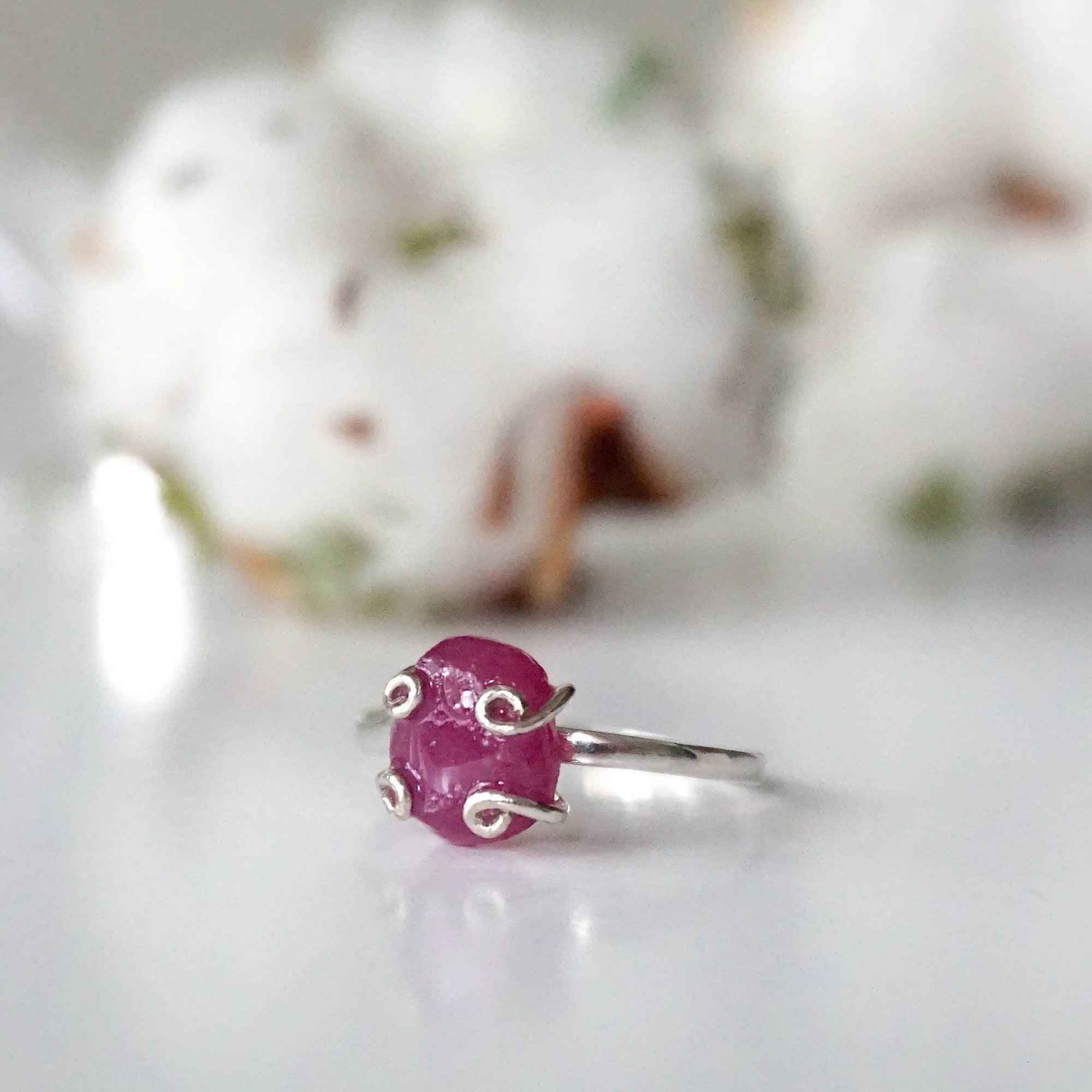 Left side view of pink ruby adjustable ring highlighting natural raw stone and slim 925 sterling silver band — July birthstone ring