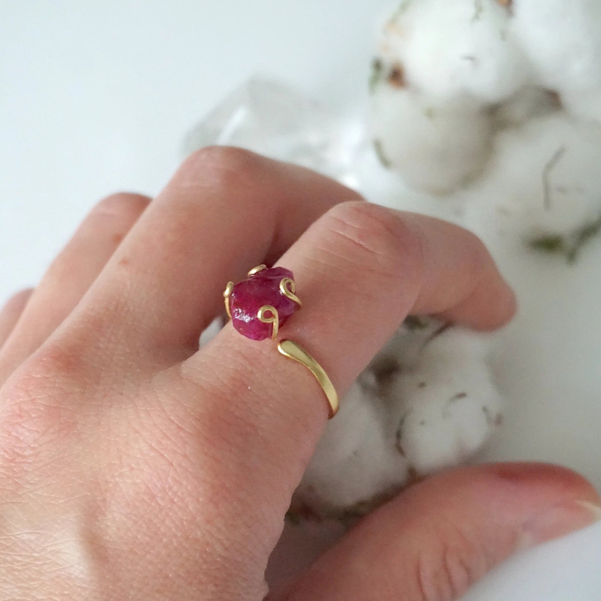Pink ruby adjustable ring worn on female model's hand — natural raw ruby in 14k gold vermeil setting, July birthstone ring for women