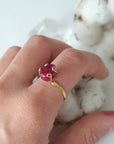 Pink ruby adjustable ring worn on female model's hand — natural raw ruby in 14k gold vermeil setting, July birthstone ring for women