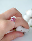 Pink ruby adjustable ring worn on female model's hand — natural raw ruby in 925 sterling silver setting, July birthstone ring for women