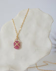 Back angle of natural pink ruby pendant in 14k gold vermeil prong setting — minimalist handmade crystal necklace, gold filled chain