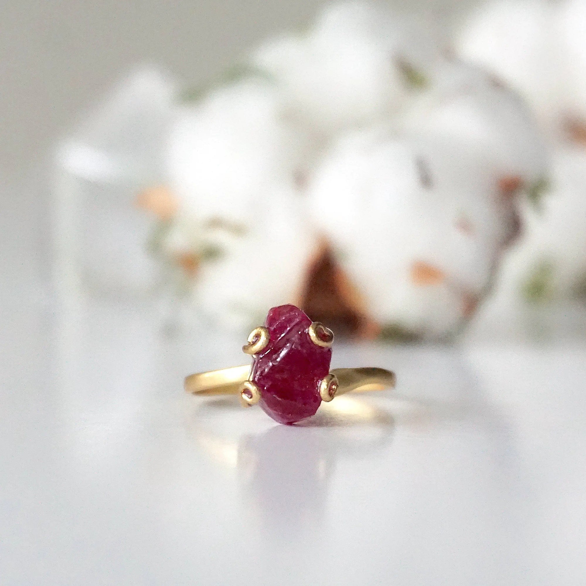 Front view of pink ruby adjustable ring showing natural raw ruby stone in curled 14k gold vermeil setting — handmade crystal ring for women