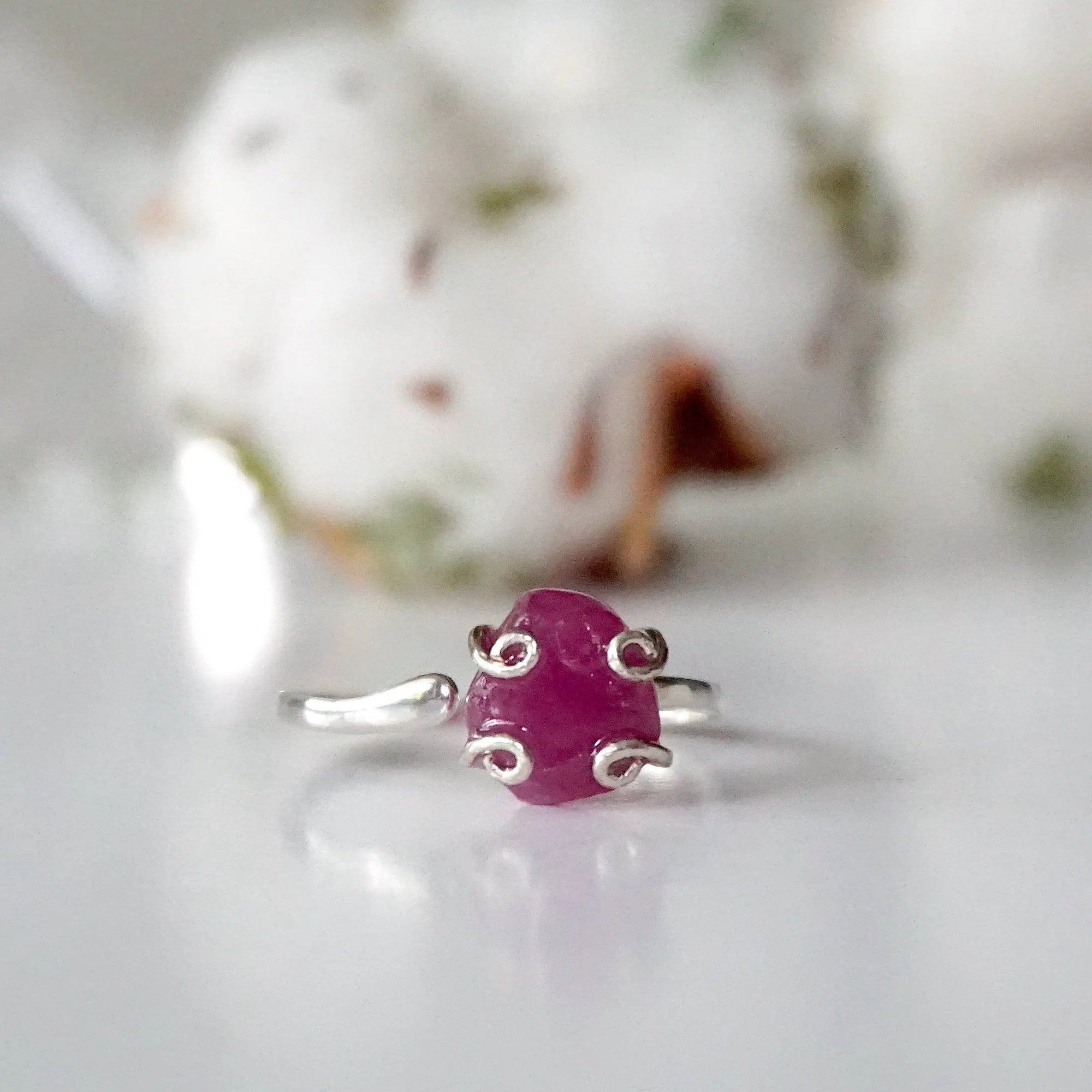 Front view of pink ruby adjustable ring showing natural raw ruby stone in curled 925 sterling silver setting — handmade crystal ring for women
