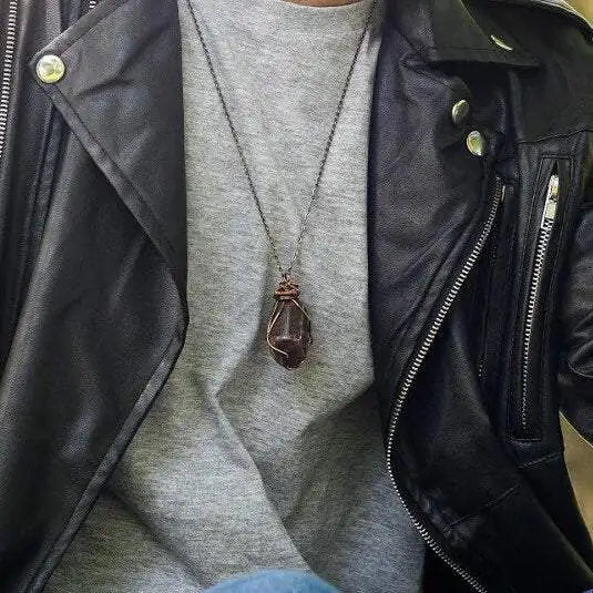 Male model wearing large polished raw ruby necklace on antique bronze chain — men's handmade statement crystal jewelry by Designs by Nature Gems