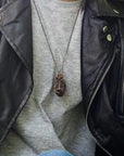 Male model wearing large polished raw ruby necklace on antique bronze chain — men's handmade statement crystal jewelry by Designs by Nature Gems