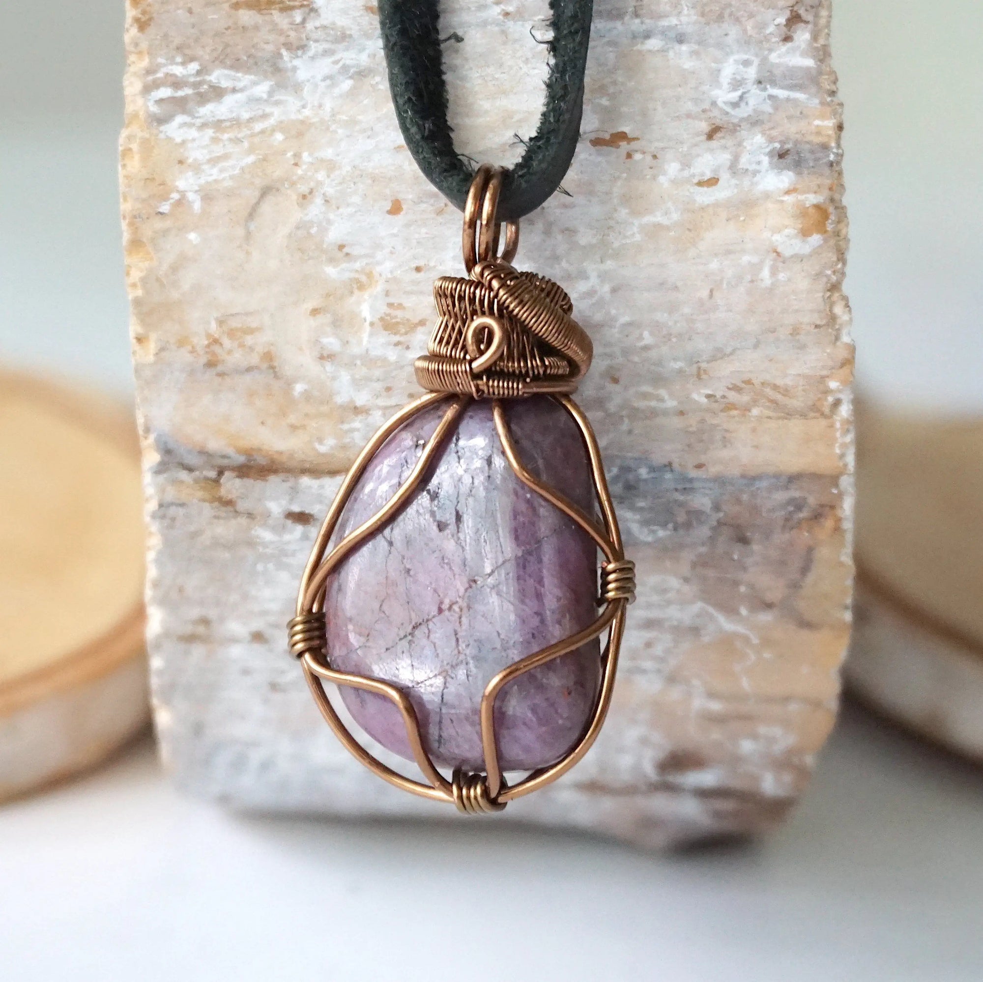 Back angle of men's large polished raw ruby pendant displaying antique bronze wire wrapping craftsmanship — handmade artisan crystal jewelry, nickel-free
