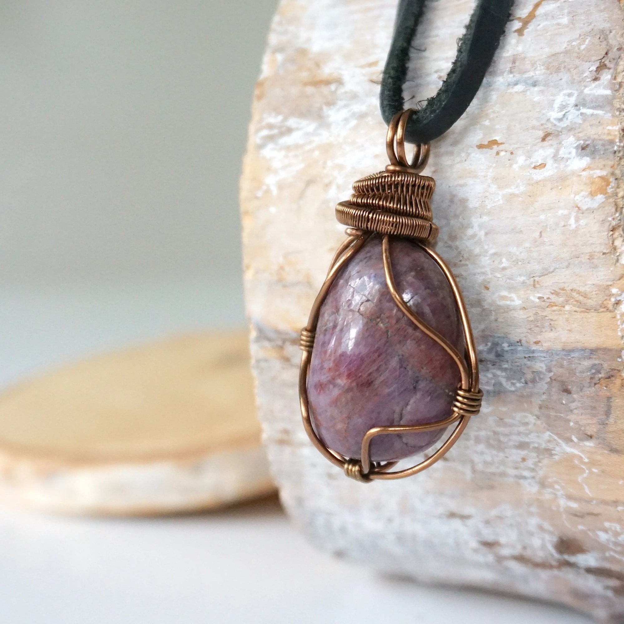 Left side view of large polished raw ruby pendant highlighting antique bronze wire wrap craftsmanship — men's statement crystal necklace, nickel-free copper wire