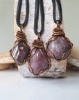 Three natural polished raw ruby pendants side by side showing unique variation in size, shape, and colour — each one of a kind by nature, men's crystal necklace