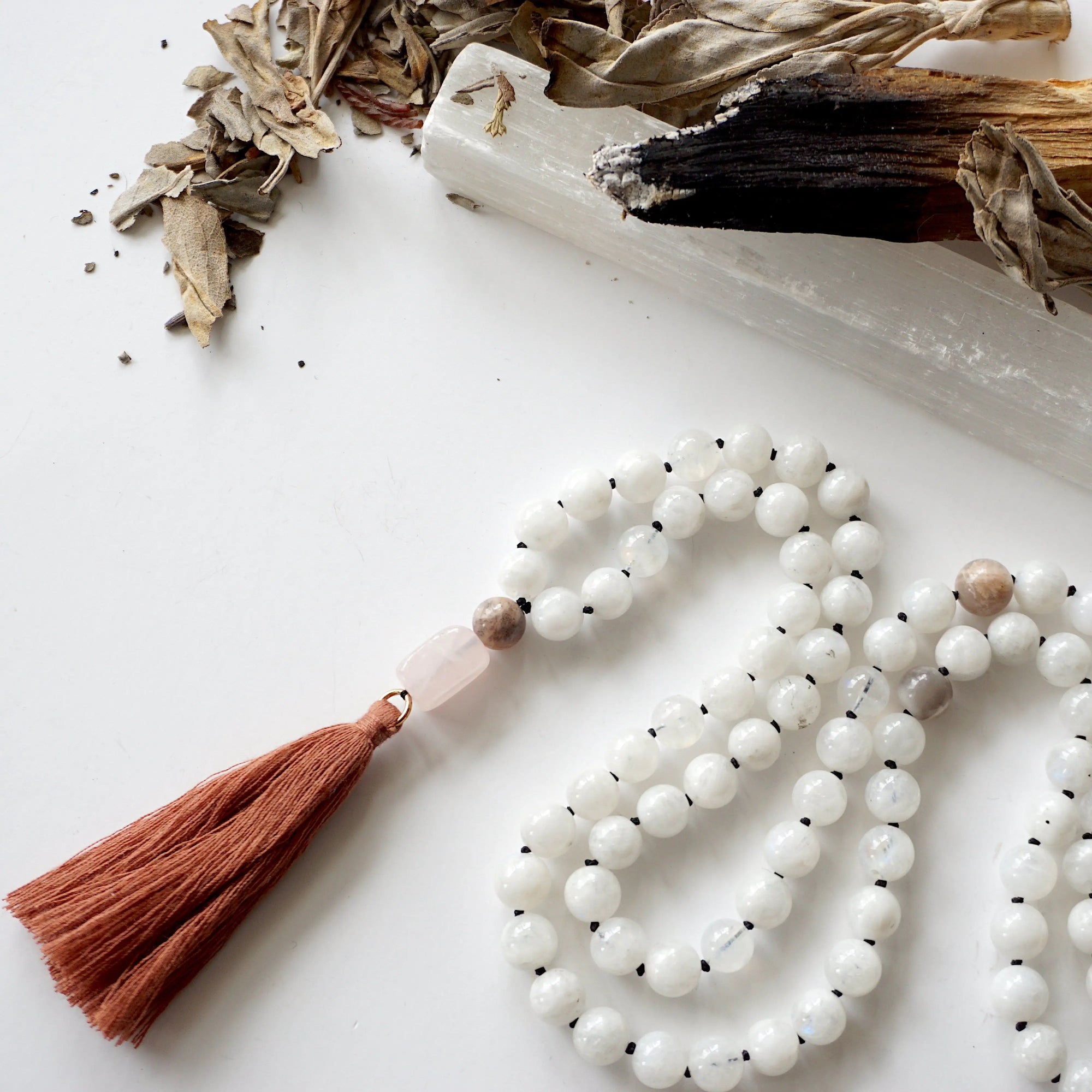 Close-up of natural 8mm rainbow moonstone and moonstone beads on hand knotted mala necklace, June birthstone meditation beads.