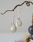 Close-up of rainbow moonstone drop earrings with natural 8mm moonstone beads in intricate soft silver wire wrap, June birthstone dangle earrings.