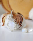 Front view of rainbow moonstone jewelry set with sterling silver wire wrapped cabochon pendant and raw moonstone stud earrings (June birthstone).