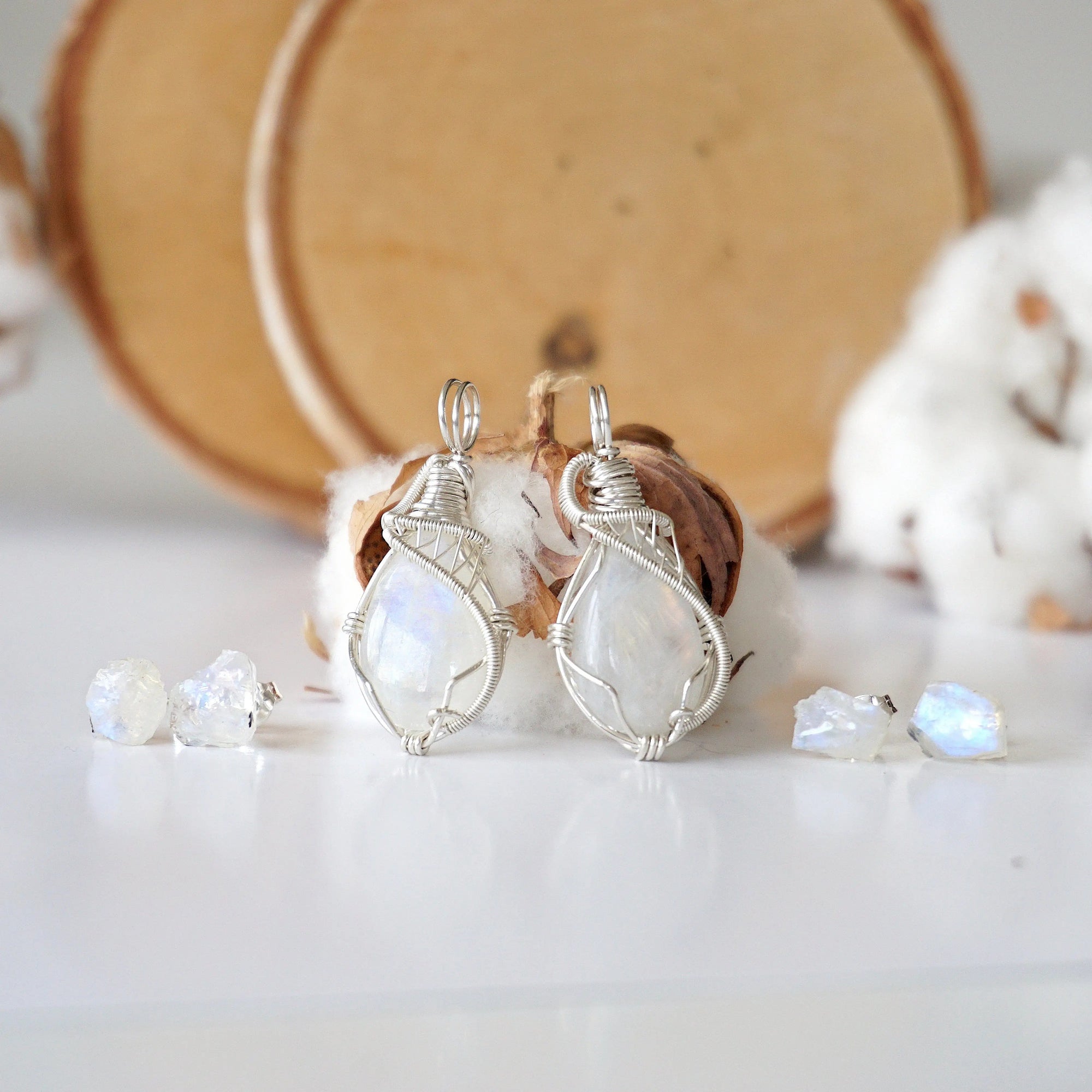 Two rainbow moonstone necklace and earrings sets showing natural variation in moonstone size, shape, and blue flash (June birthstone).