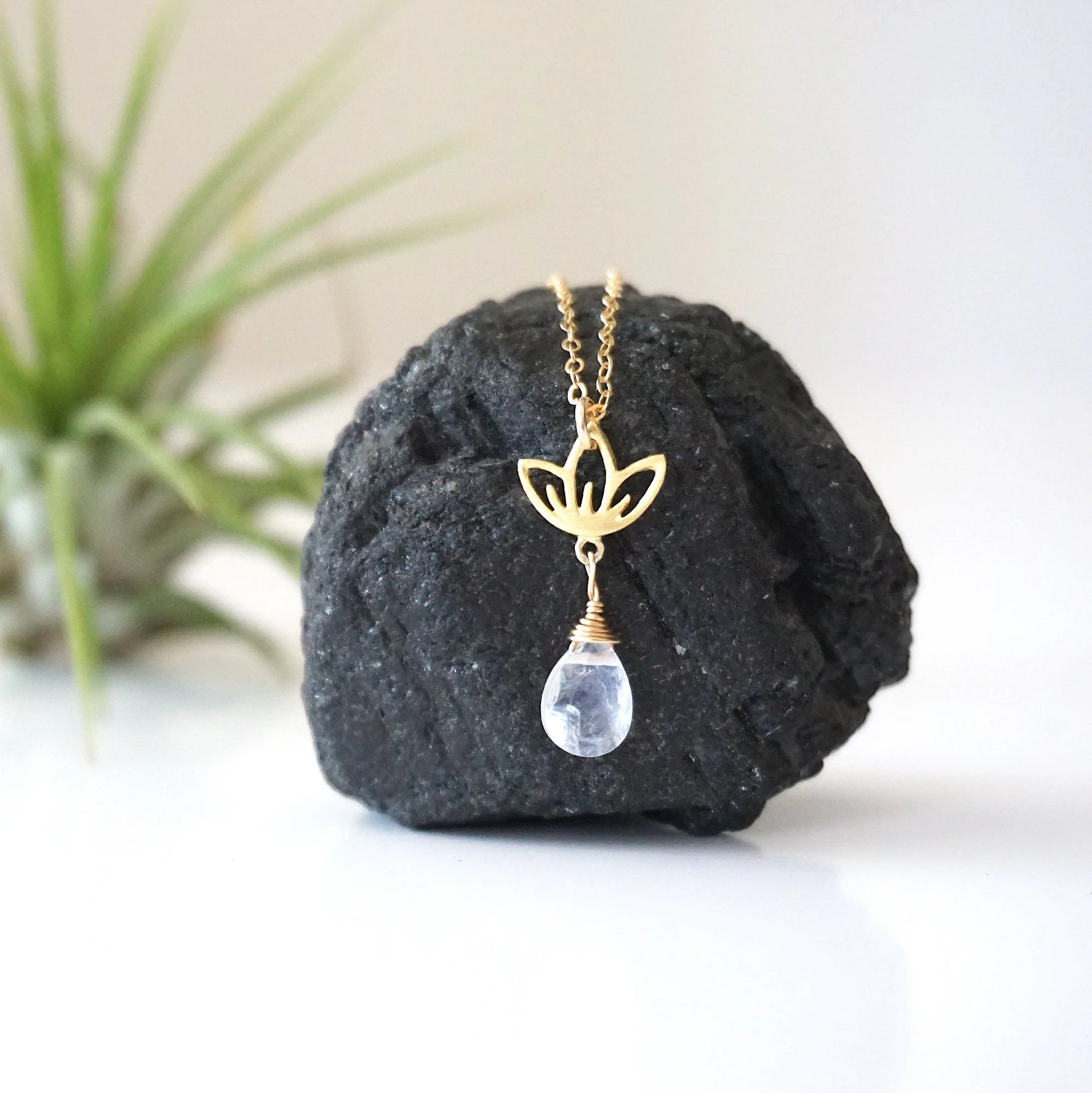 Close-up of rainbow moonstone and lotus necklace for women, faceted pear rainbow moonstone drop with gold vermeil lotus charm on 14k gold filled chain (June birthstone).