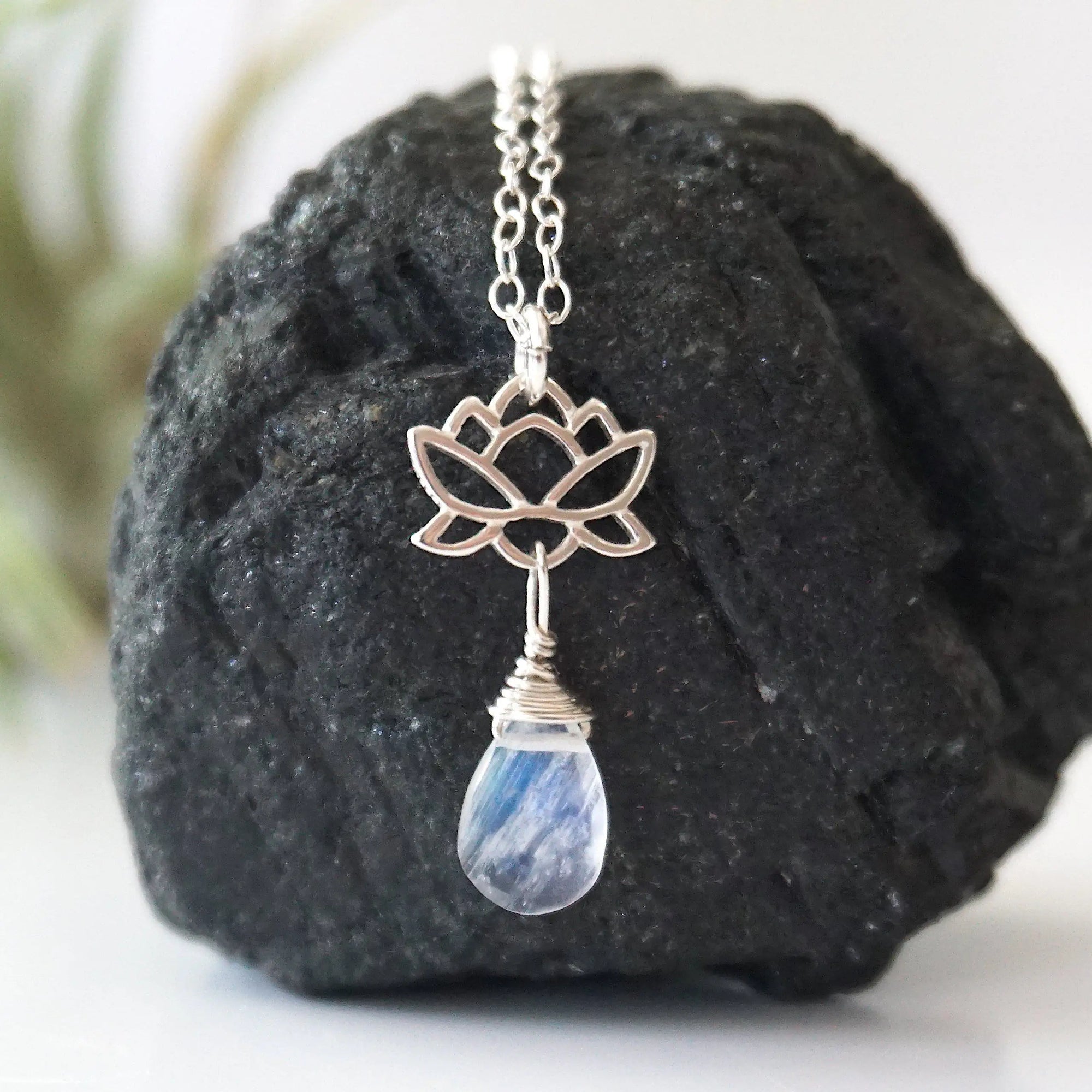Close-up of rainbow moonstone and lotus necklace for women, faceted pear rainbow moonstone drop with 925 sterling silver lotus charm on sterling silver chain (June birthstone).