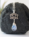 Close-up of rainbow moonstone and lotus necklace for women, faceted pear rainbow moonstone drop with 925 sterling silver lotus charm on sterling silver chain (June birthstone).
