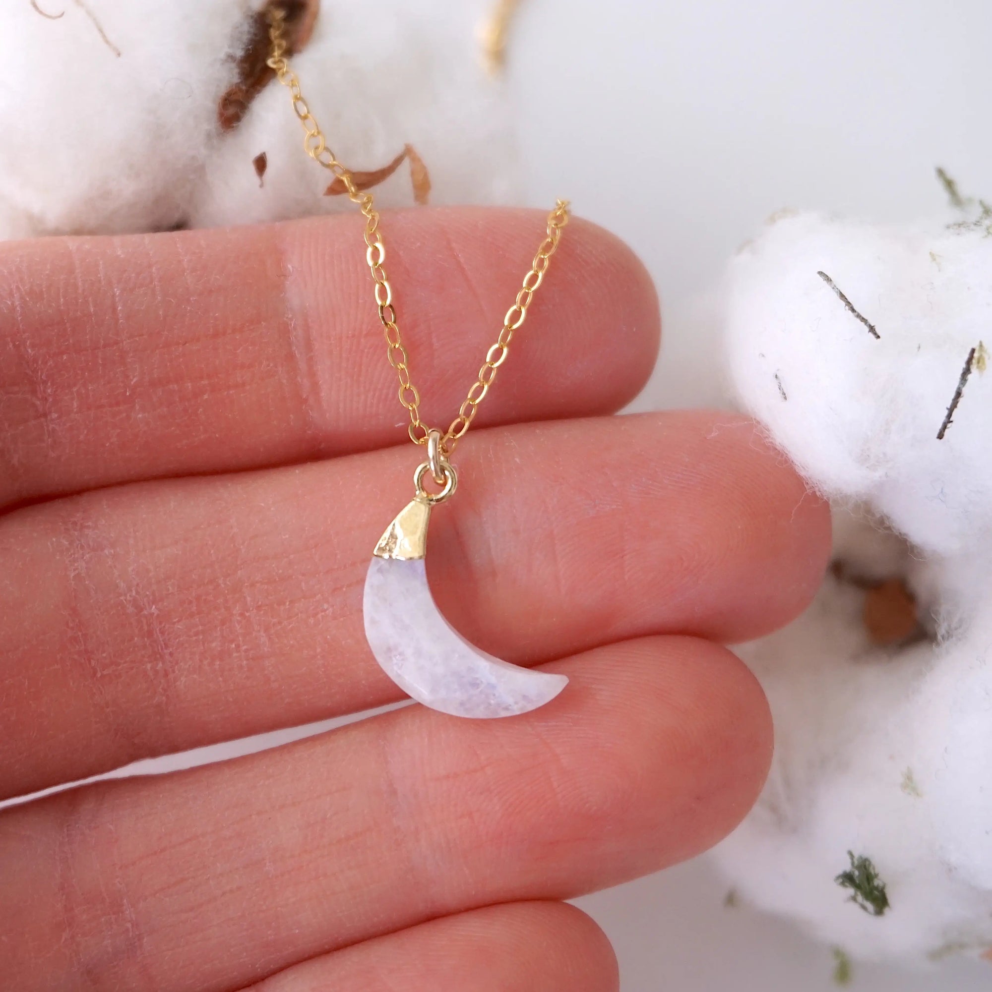 In-hand close-up of rainbow moonstone moon necklace for women, faceted crescent moon pendant in 14k gold vermeil on 18 inch 14k gold filled chain (June birthstone).