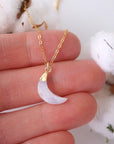 In-hand close-up of rainbow moonstone moon necklace for women, faceted crescent moon pendant in 14k gold vermeil on 18 inch 14k gold filled chain (June birthstone).