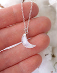In-hand close-up of rainbow moonstone moon necklace for women, faceted crescent moon pendant in 925 sterling silver on 18 inch sterling silver chain (June birthstone).