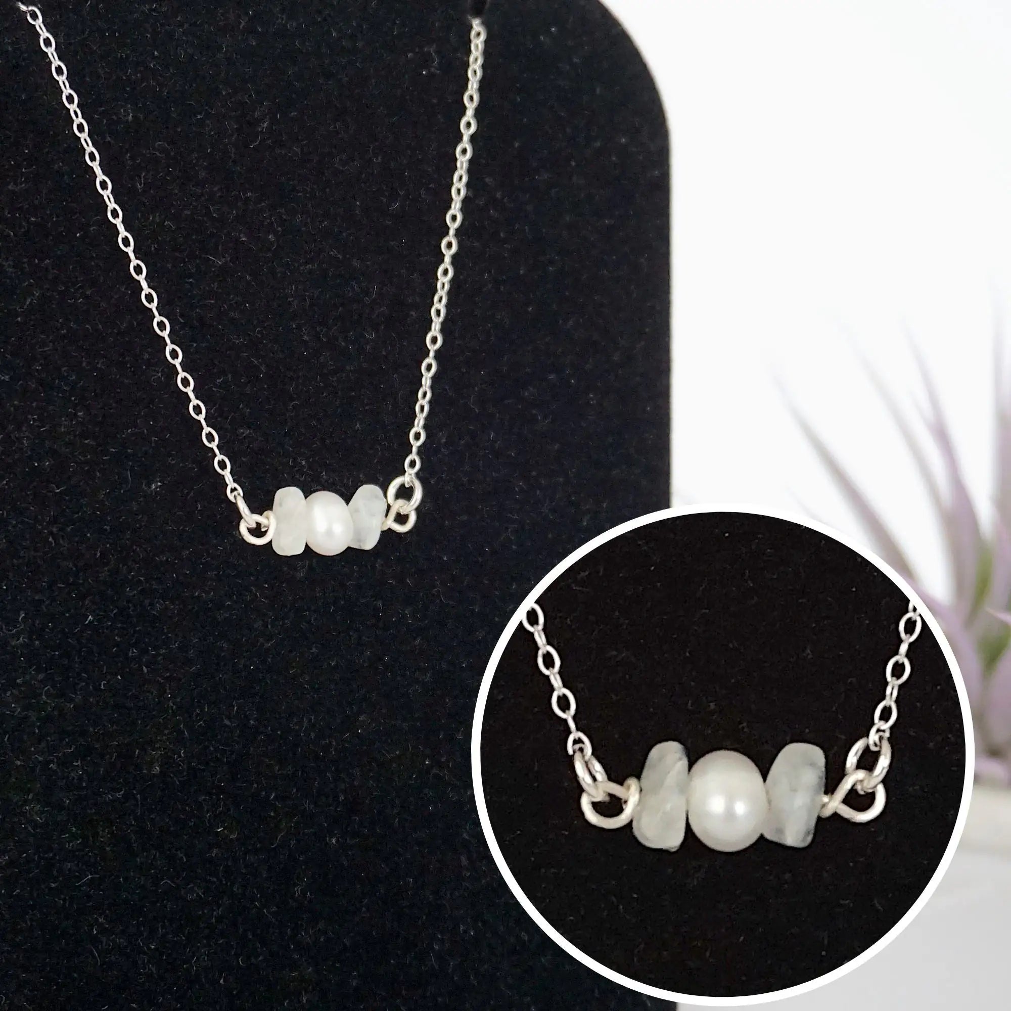 Close-up of raw rainbow moonstone stones and freshwater pearl bar on 925 sterling silver necklace