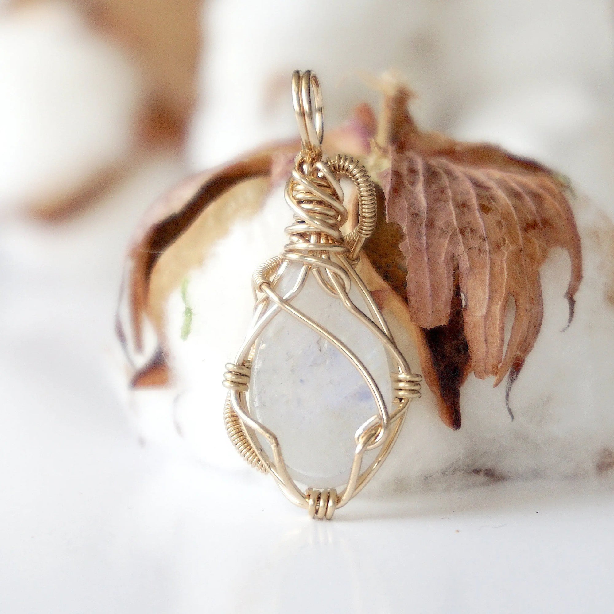 Back angle view of rainbow moonstone pendant showing detailed handcrafted 14k gold filled wire wrapping