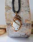 Back angle view of rainbow moonstone pendant showing detailed handcrafted mixed metal wire wrapping for men