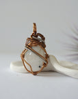 Back angle view of rainbow moonstone pendant showing detailed handcrafted mixed metal wire wrapping