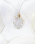 Back view of artisan wire wrapped rainbow moonstone cabochon pendant in sterling silver and 14k gold filled.
