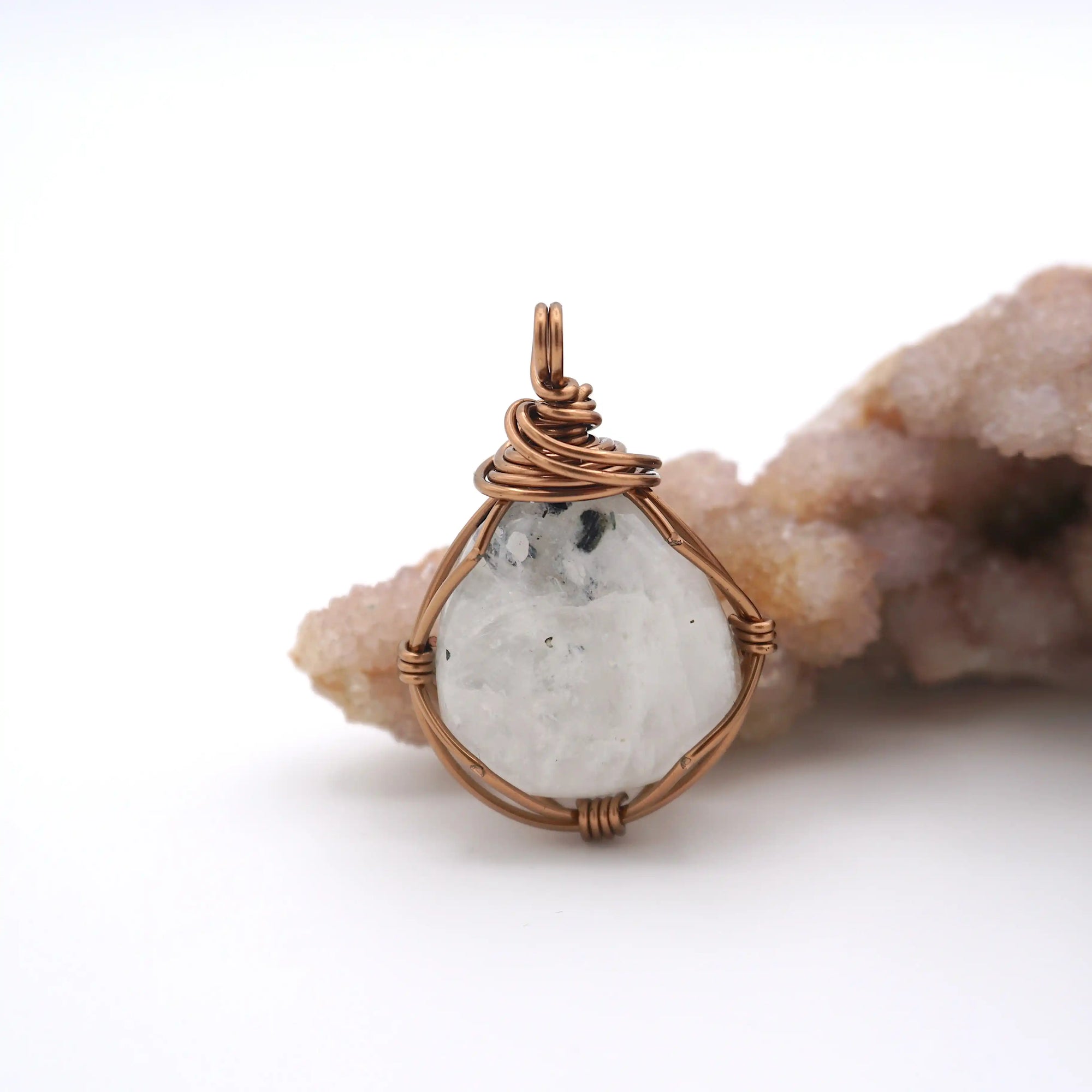Front angle view of natural rainbow moonstone pendant with artisan antique bronze copper wire wrapping for all genders