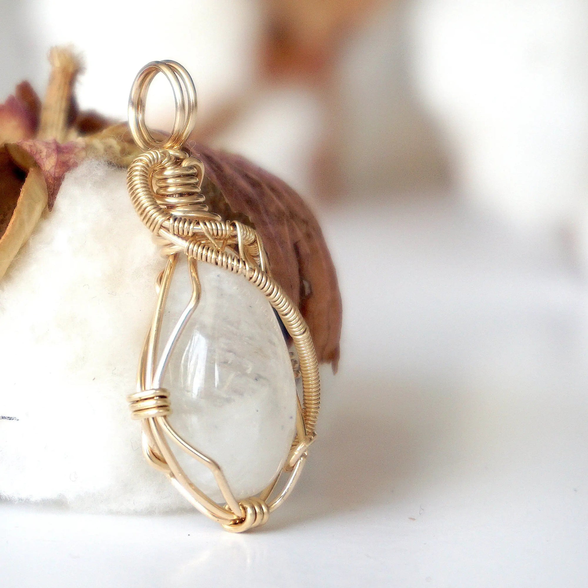 Right angle view of rainbow moonstone pendant showing handcrafted 14k gold filled wire wrapping detail