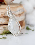 Right angle view of rainbow moonstone pendant showing detailed handcrafted 925 sterling silver wire wrapping