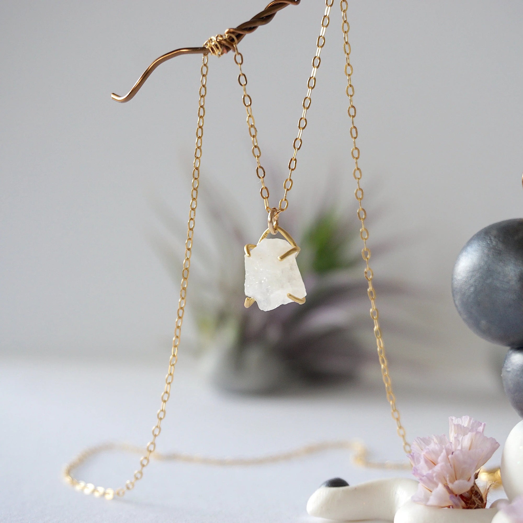 Side angle close-up of raw rainbow moonstone pendant showing 14k gold vermeil prong setting on minimalist June birthstone necklace.