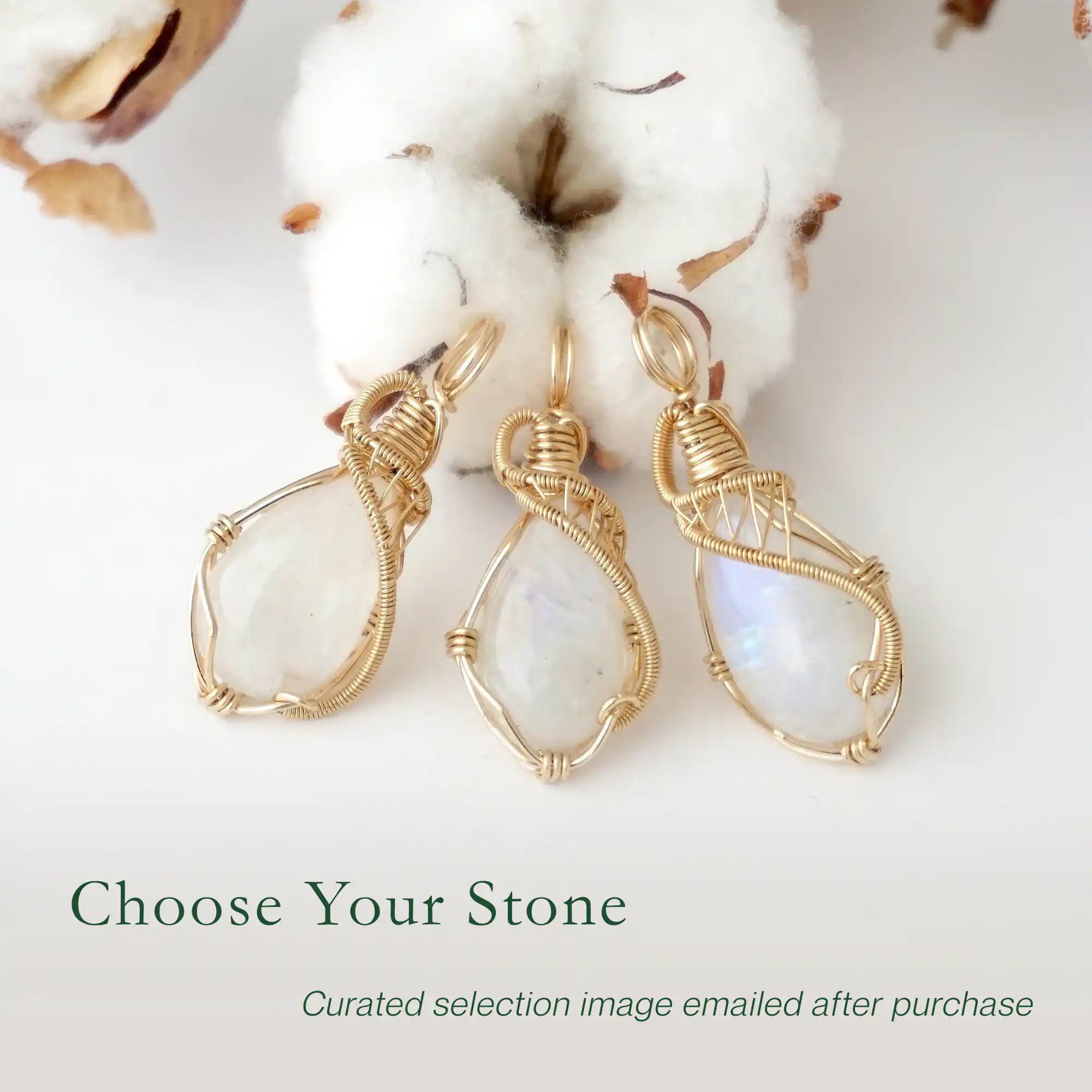 Three rainbow moonstone pendants showing natural variation in size and flash in handmade artisan jewelry